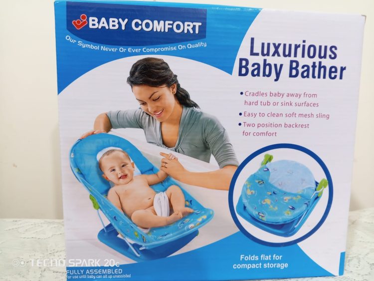 The packaging highlights that the bather cradles the baby away from hard surfaces and folds flat for compact storage.