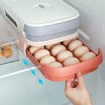 A red egg storage box with a drawer and auto-scrolling design, featuring a freshness-keeping timetable on the cover and a three-track system for holding 18-21 eggs.