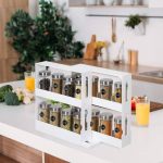 Compact two-tier adjustable spice rack organizer with sliding drawers, made of durable white plastic, neatly arranged in a kitchen cabinet