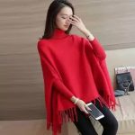 High-neck knit poncho with tassels in black, grey, pink, and red