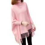 Woman wearing a pink knit poncho sweater with high neckline and fringe tassels, perfect for winter fashion.