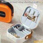 Mini jewelry box with compartments for rings, earrings, and necklaces in orange and white color