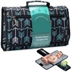 Baby lying on a foldable padded diaper changing mat with built-in wipes and organizer pouch, perfect for travel and newborn care.